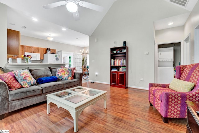 8 Knob Creek Ct, Greer, SC 29651 - living room featuring stacked washer / drying machine, a chandelier, light wood-style flooring, ceiling fan, and baseboards
