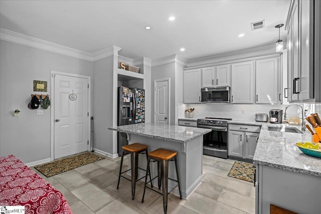3 Clifford Ct, Simpsonville, SC 29681 - kitchen featuring appliances with stainless steel finishes, a kitchen bar, a sink, tasteful backsplash, and light stone countertops