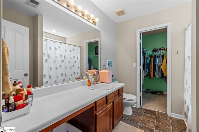 3 Clifford Ct, Simpsonville, SC 29681 - full bathroom featuring vanity, toilet, a spacious closet, stone finish floors, and baseboards