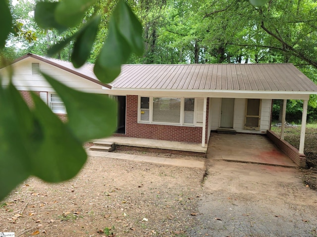 200 Lincoln Dr, Gaffney, SC 29341 - ranch-style house featuring brick siding, an attached carport, driveway, metal roof, and a porch