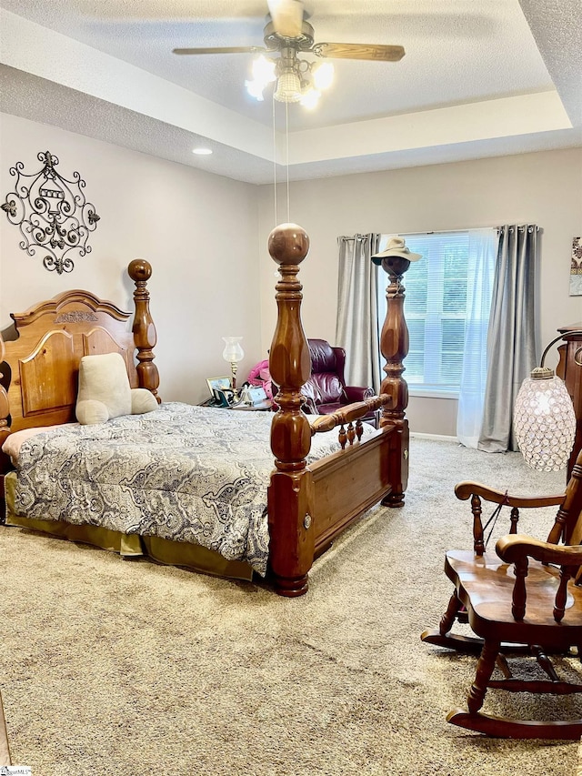 191 Amberwood Dr, Anderson, SC 29621 - carpeted bedroom featuring a tray ceiling, a textured ceiling, and a ceiling fan