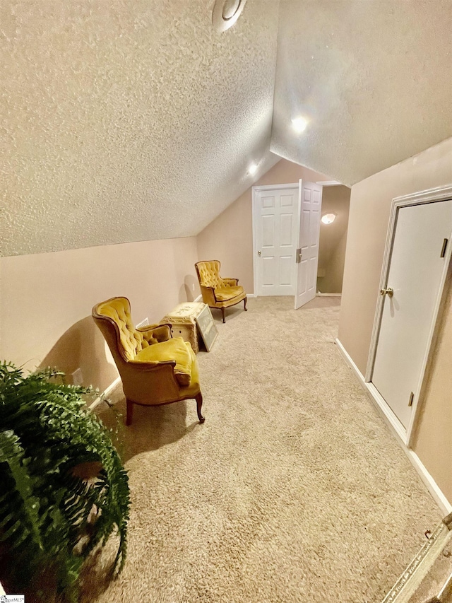 191 Amberwood Dr, Anderson, SC 29621 - living area featuring a textured ceiling, lofted ceiling, carpet floors, and baseboards