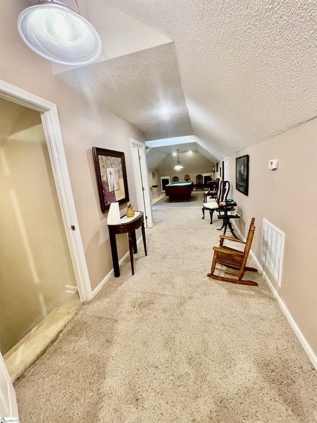 191 Amberwood Dr, Anderson, SC 29621 - living area featuring lofted ceiling, a textured ceiling, carpet flooring, and baseboards