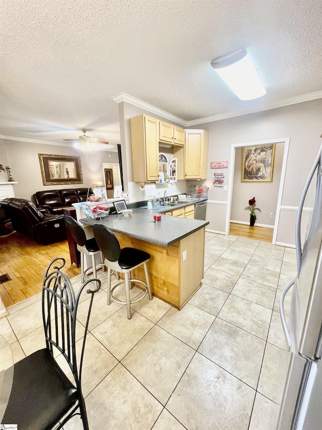 191 Amberwood Dr, Anderson, SC 29621 - kitchen featuring a peninsula, dishwasher, light brown cabinets, a textured ceiling, and fridge