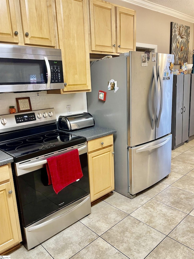 191 Amberwood Dr, Anderson, SC 29621 - kitchen featuring appliances with stainless steel finishes, decorative backsplash, crown molding, light tile patterned floors, and dark countertops