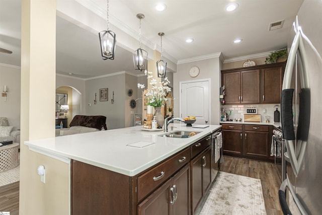 111 Crisp Cameo Ct, Greer, SC 29651 - kitchen featuring freestanding refrigerator, a sink, dark wood finished floors, arched walkways, and light countertops