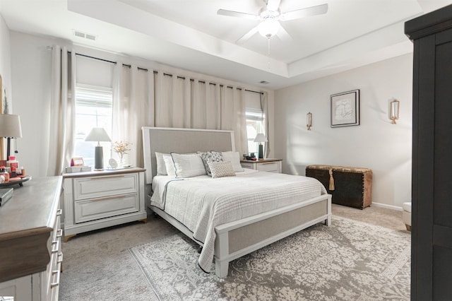 111 Crisp Cameo Ct, Greer, SC 29651 - bedroom with light carpet, multiple windows, a tray ceiling, and ceiling fan