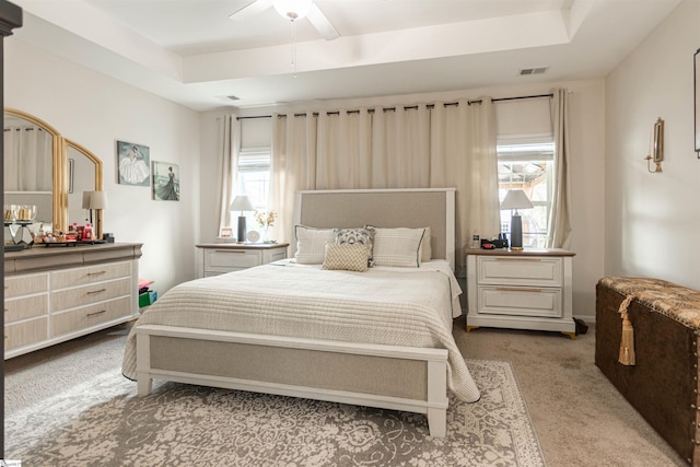 111 Crisp Cameo Ct, Greer, SC 29651 - carpeted bedroom with a tray ceiling, multiple windows, and ceiling fan