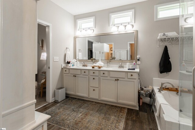 111 Crisp Cameo Ct, Greer, SC 29651 - bathroom with double vanity, wood finished floors, plenty of natural light, and a tub to relax in