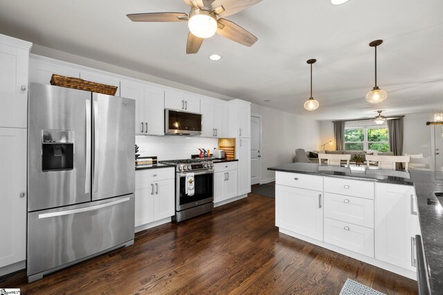 26 Briarcliff Dr, Greenville, SC 29607 - kitchen with appliances with stainless steel finishes, dark countertops, a ceiling fan, dark wood-style floors, and backsplash