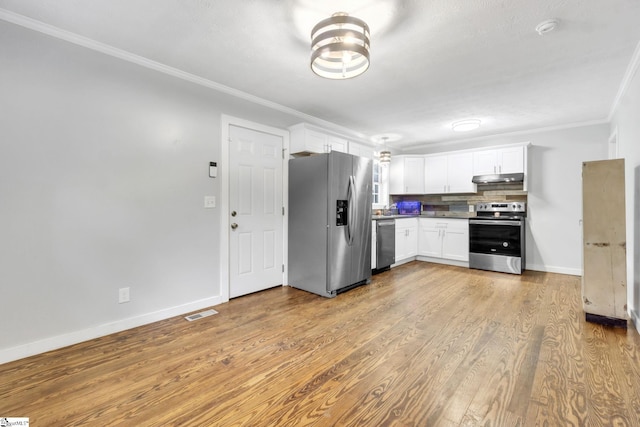 103 Cumbahee Trl, Greenville, SC 29611 - kitchen with stainless steel appliances, under cabinet range hood, white cabinets, ornamental molding, and decorative backsplash