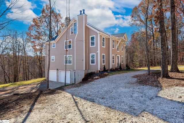 183 Wittmore Ln, Cleveland, SC 29635 - view of home's exterior with concrete driveway, a chimney, and a garage
