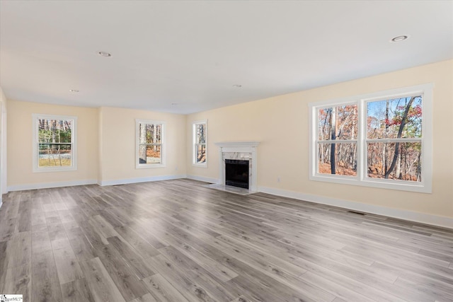 183 Wittmore Ln, Cleveland, SC 29635 - unfurnished living room with light wood-type flooring, a high end fireplace, baseboards, and recessed lighting