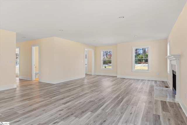183 Wittmore Ln, Cleveland, SC 29635 - unfurnished living room featuring light wood-style floors, a fireplace with flush hearth, baseboards, and recessed lighting