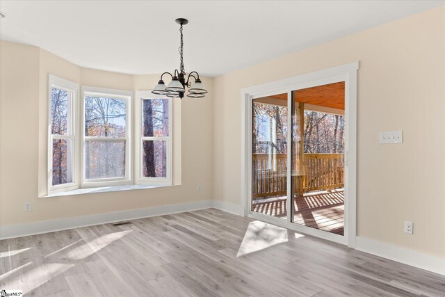 183 Wittmore Ln, Cleveland, SC 29635 - unfurnished dining area featuring a chandelier, wood finished floors, and baseboards