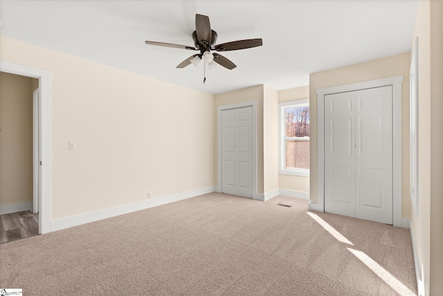 183 Wittmore Ln, Cleveland, SC 29635 - unfurnished bedroom with light carpet, two closets, baseboards, and ceiling fan