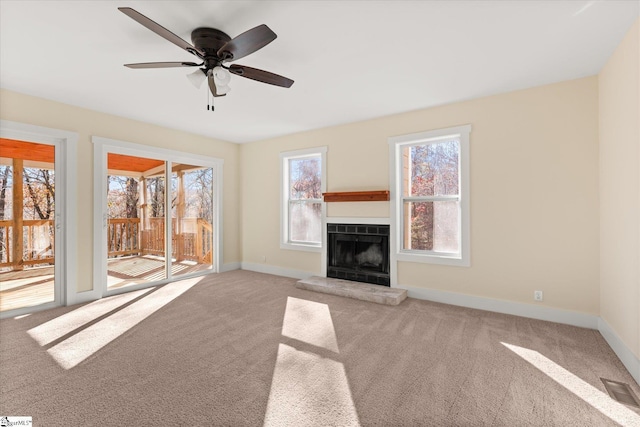 183 Wittmore Ln, Cleveland, SC 29635 - unfurnished living room with carpet flooring, a fireplace with raised hearth, baseboards, and a ceiling fan