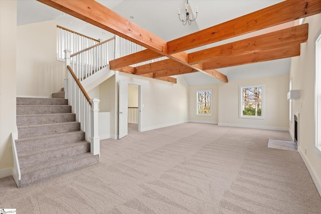 183 Wittmore Ln, Cleveland, SC 29635 - unfurnished living room featuring carpet flooring, beam ceiling, stairs, baseboards, and a fireplace with flush hearth