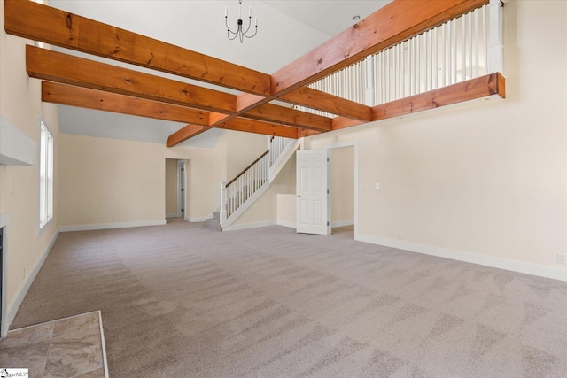 183 Wittmore Ln, Cleveland, SC 29635 - unfurnished living room featuring carpet flooring, stairs, baseboards, and beamed ceiling
