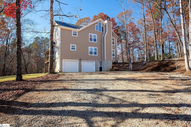 183 Wittmore Ln, Cleveland, SC 29635 - view of home's exterior with a garage and a chimney
