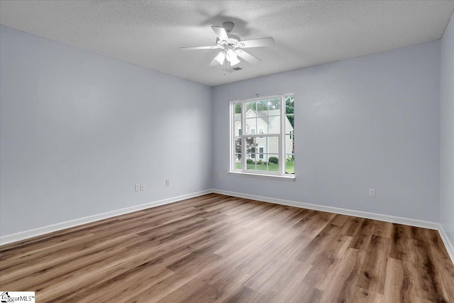 316 Stillwater Dr, Simpsonville, SC 29681 - empty room with ceiling fan, wood finished floors, baseboards, and a textured ceiling