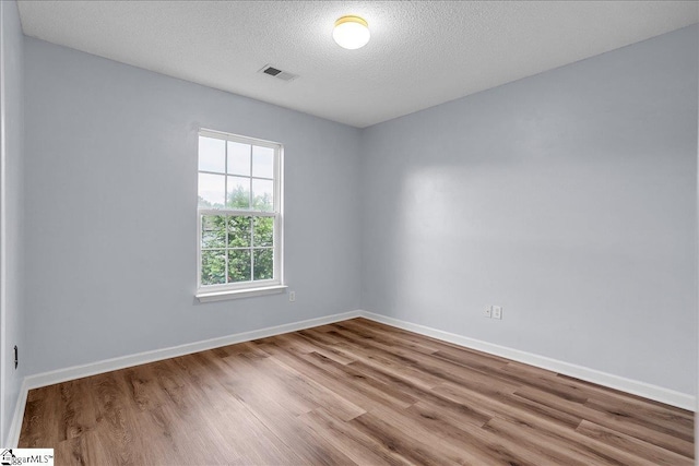 316 Stillwater Dr, Simpsonville, SC 29681 - empty room featuring wood finished floors, a textured ceiling, and baseboards