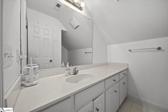 123 S Lake Emory Dr, Inman, SC 29349 - bathroom with vaulted ceiling, vanity, tile patterned flooring, a textured ceiling, and baseboards