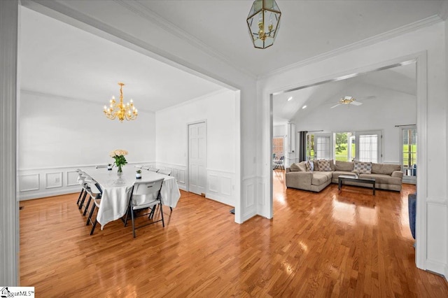 123 S Lake Emory Dr, Inman, SC 29349 - dining area featuring a chandelier, lofted ceiling, a decorative wall, light wood-style floors, and a wainscoted wall
