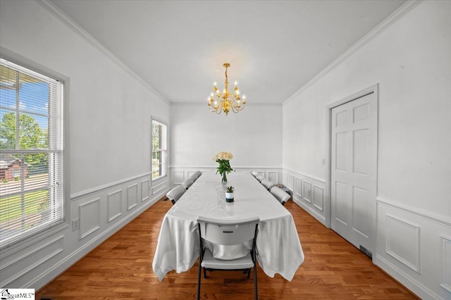 123 S Lake Emory Dr, Inman, SC 29349 - dining area featuring a chandelier, ornamental molding, wainscoting, wood finished floors, and a decorative wall