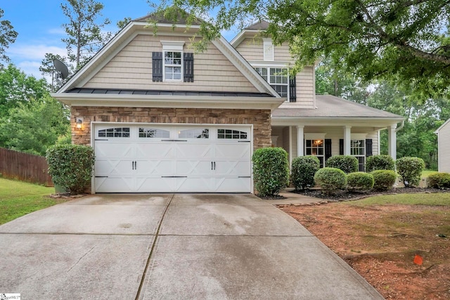 103 Groveview Trl, Mauldin, SC 29662 - view of front facade featuring driveway, a garage, stone siding, and covered porch