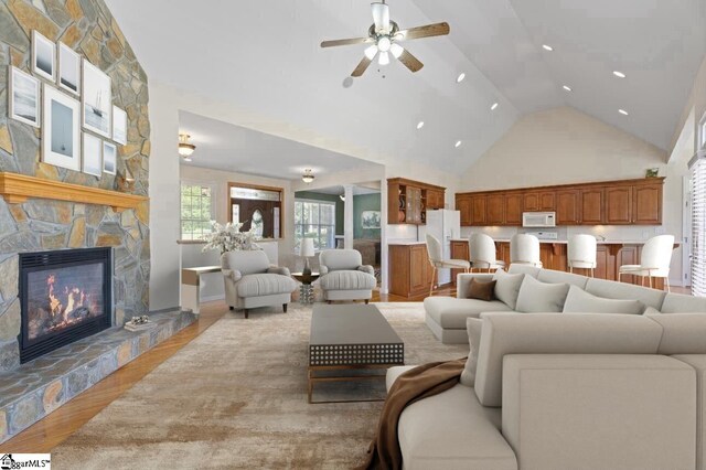 404 N Tidewater Trl, Inman, SC 29349 - living area featuring ceiling fan, light wood-style flooring, high vaulted ceiling, and a stone fireplace