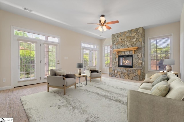 404 N Tidewater Trl, Inman, SC 29349 - carpeted living room featuring a stone fireplace, healthy amount of natural light, baseboards, and ceiling fan