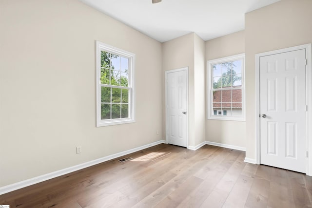 1316 E S 6th St, Seneca, SC 29678 - unfurnished bedroom with multiple windows, baseboards, and wood finished floors