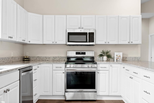 1316 E S 6th St, Seneca, SC 29678 - kitchen featuring appliances with stainless steel finishes, white cabinetry, and light stone countertops