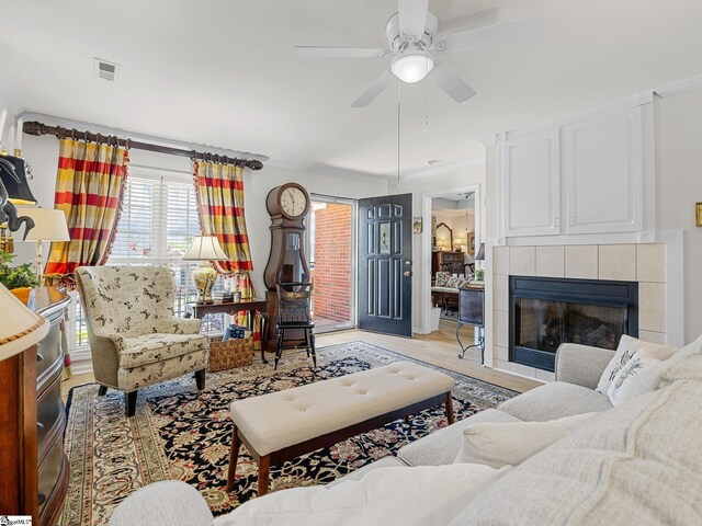312 Terrace Hills Dr, Boiling Springs, SC 29316 - living room featuring crown molding, a ceiling fan, a tile fireplace, and light wood-style floors