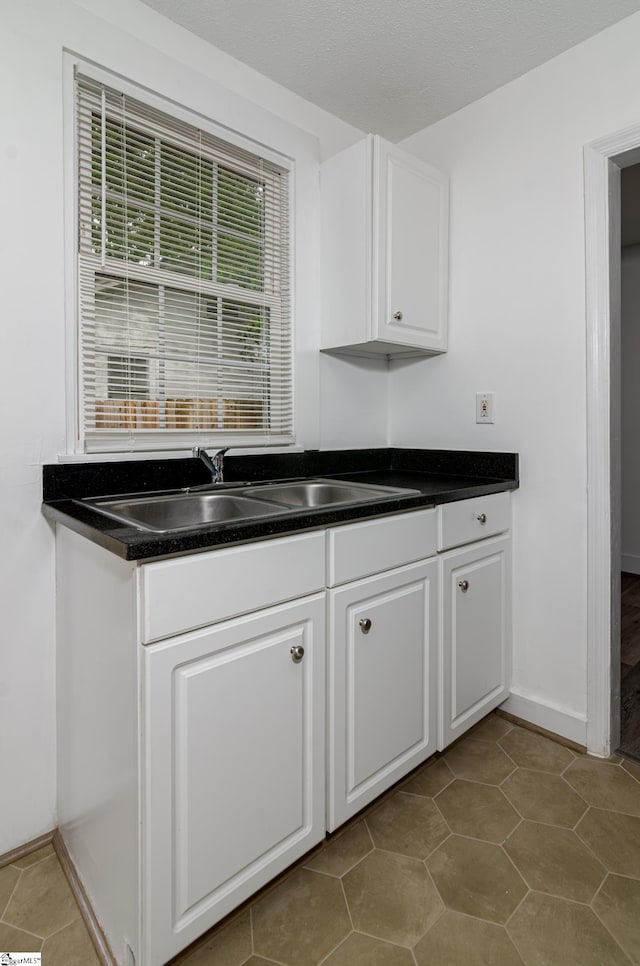 208 Arlington Avenue Unit A And B, Anderson, SC 29621 - kitchen featuring dark countertops, a sink, white cabinets, and baseboards