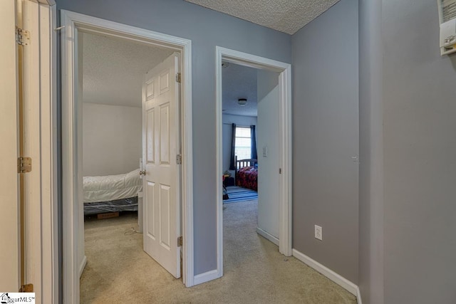 406 Standing Rock Dr, Boiling Springs, SC 29316 - hall with a textured ceiling, light colored carpet, and baseboards