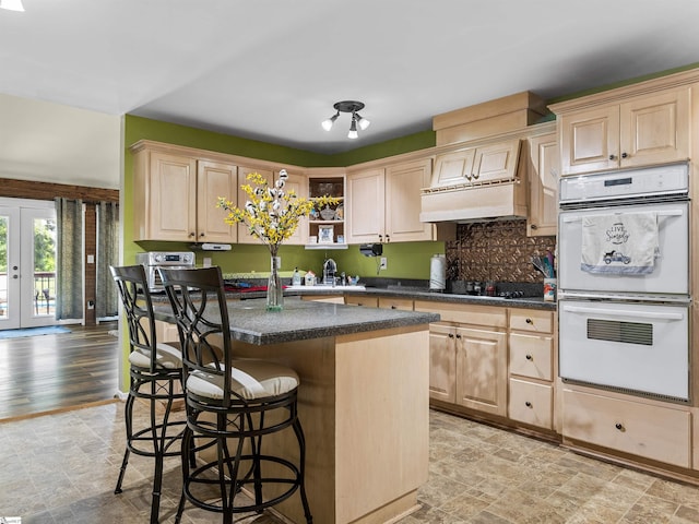 112 Scruggs Ln, Gaffney, SC 29341 - kitchen with light brown cabinets, double oven, stone finish flooring, and a breakfast bar area