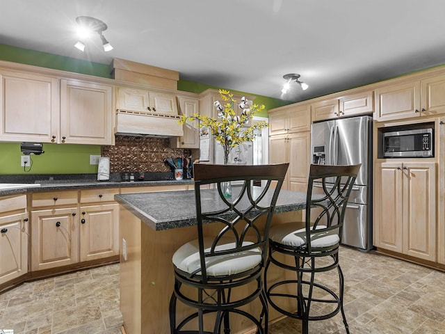 112 Scruggs Ln, Gaffney, SC 29341 - kitchen with stainless steel appliances, stone finish floors, a kitchen breakfast bar, backsplash, and dark countertops