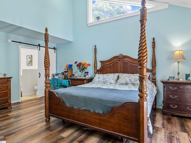 112 Scruggs Ln, Gaffney, SC 29341 - bedroom featuring dark wood-type flooring, a barn door, ensuite bath, and baseboards
