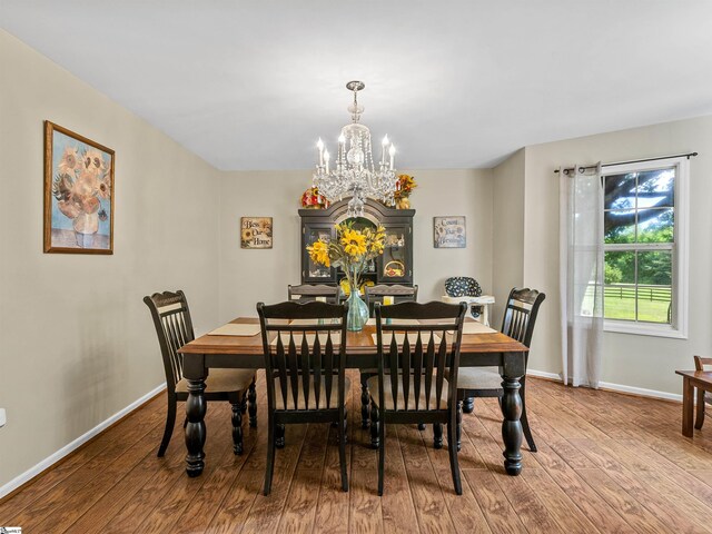 112 Scruggs Ln, Gaffney, SC 29341 - dining area featuring a chandelier, wood finished floors, and baseboards