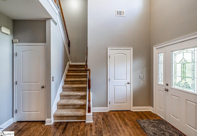 414 Mayburgh Ct, Spartanburg, SC 29301 - foyer featuring dark wood finished floors, stairway, baseboards, and a towering ceiling