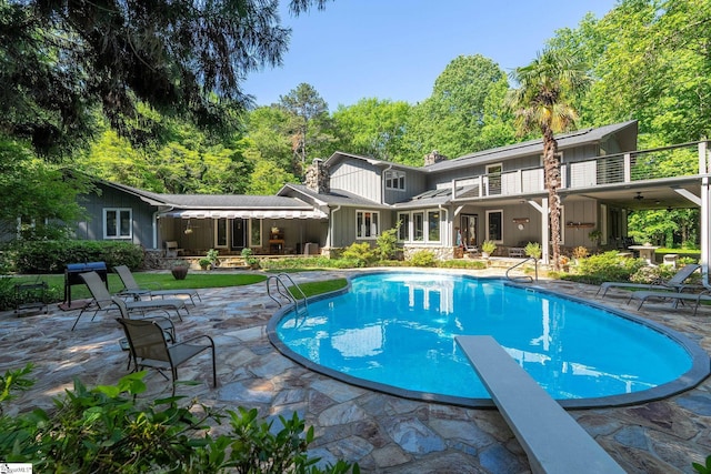 212 Middleton Shores Dr, Anderson, SC 29621 - back of house featuring board and batten siding, a patio, a chimney, an outdoor pool, and a balcony