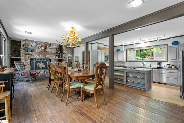 212 Middleton Shores Dr, Anderson, SC 29621 - dining area featuring a chandelier, wood-type flooring, and a fireplace