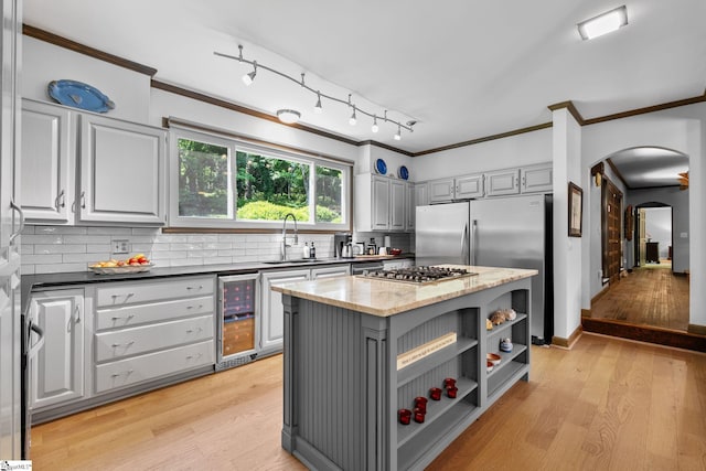 212 Middleton Shores Dr, Anderson, SC 29621 - kitchen featuring beverage cooler, gray cabinetry, a sink, arched walkways, and crown molding