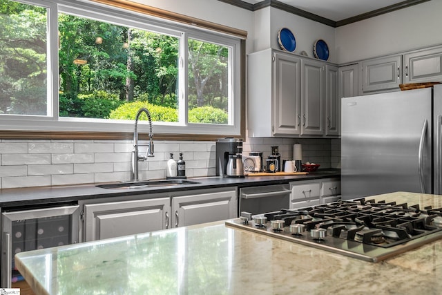 212 Middleton Shores Dr, Anderson, SC 29621 - kitchen featuring appliances with stainless steel finishes, a sink, beverage cooler, ornamental molding, and tasteful backsplash