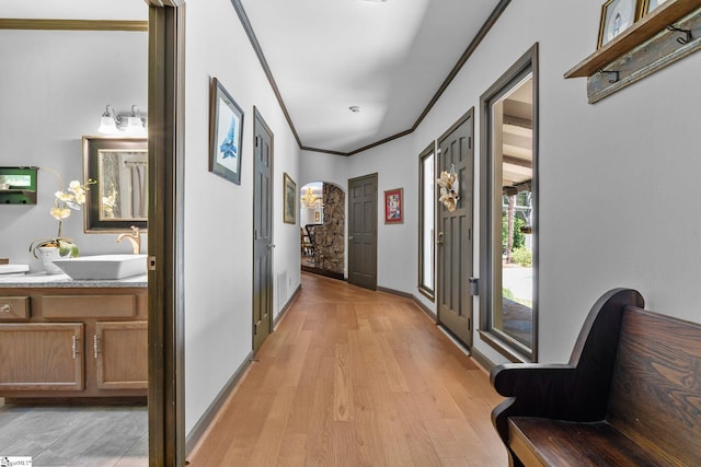 212 Middleton Shores Dr, Anderson, SC 29621 - corridor with a sink, light wood-style floors, crown molding, arched walkways, and baseboards