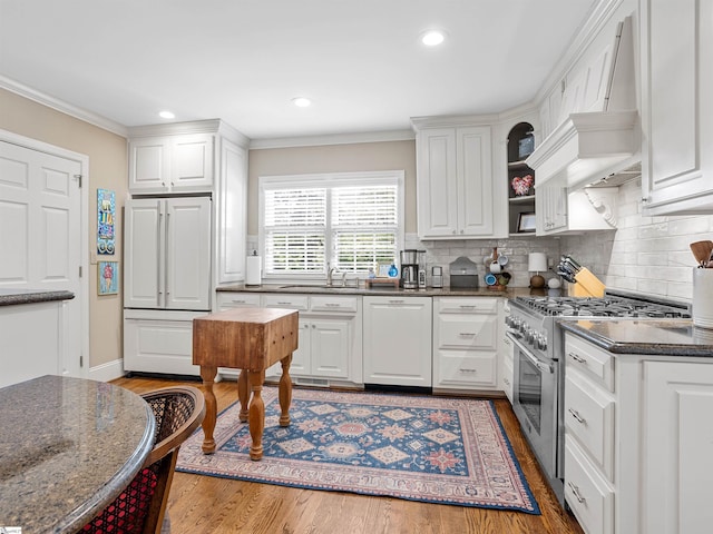 1076 Woodburn Rd, Spartanburg, SC 29302 - kitchen featuring high end appliances, wood finished floors, custom range hood, a sink, and ornamental molding