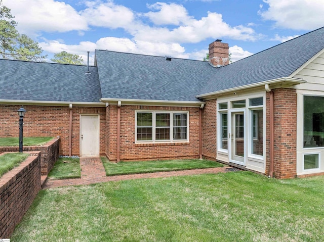 1076 Woodburn Rd, Spartanburg, SC 29302 - back of house with roof with shingles, brick siding, a chimney, and a yard