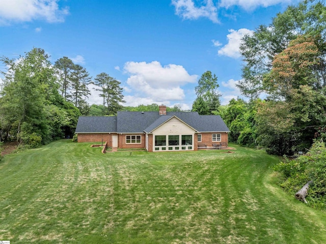 1076 Woodburn Rd, Spartanburg, SC 29302 - rear view of house with brick siding, a lawn, and a chimney